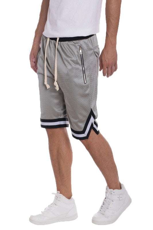 Men's solid basketball shorts with striped waistband, mesh fabric, drawstring, and zippered pockets.